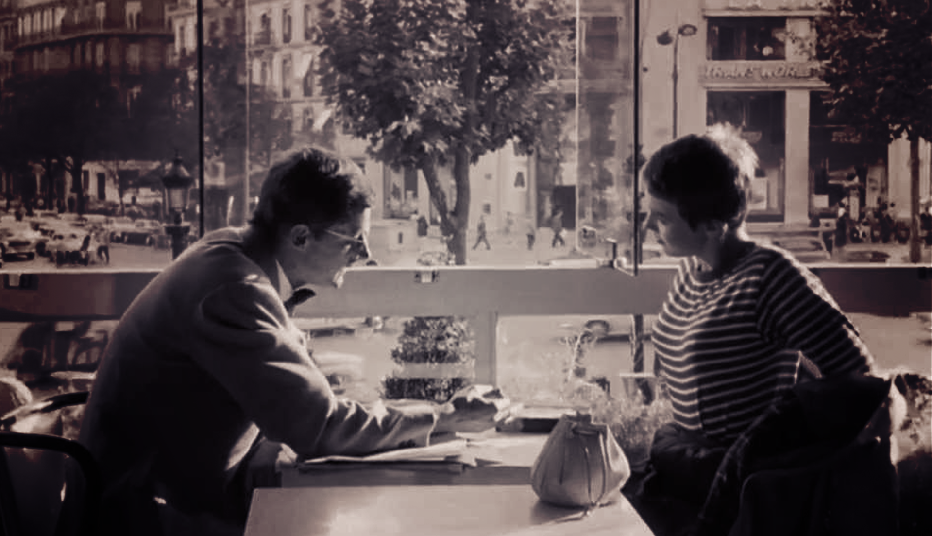 Jean Seberg and Jean-Paul Belmondo sitting in diner | Deaf Apps
