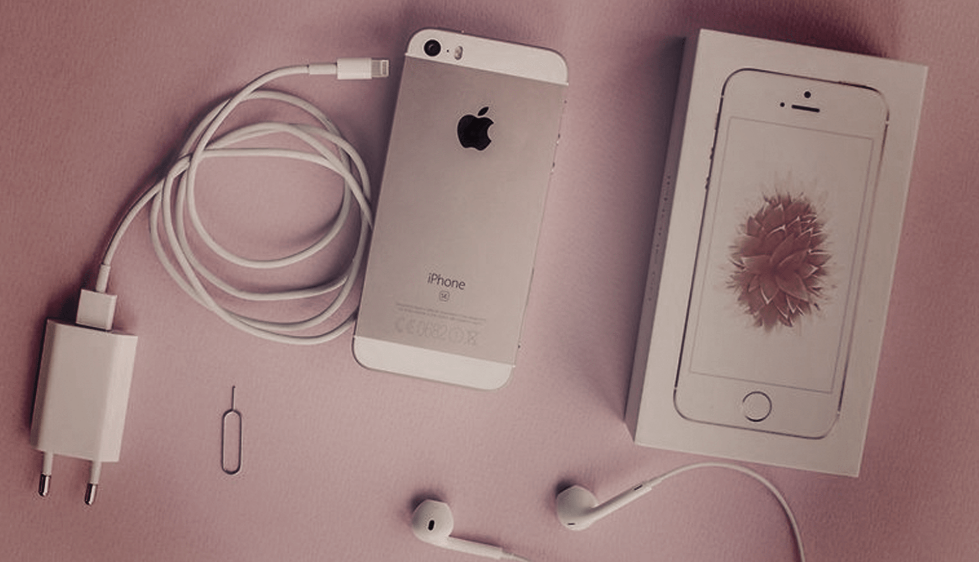 iphone SE laying on pink desk