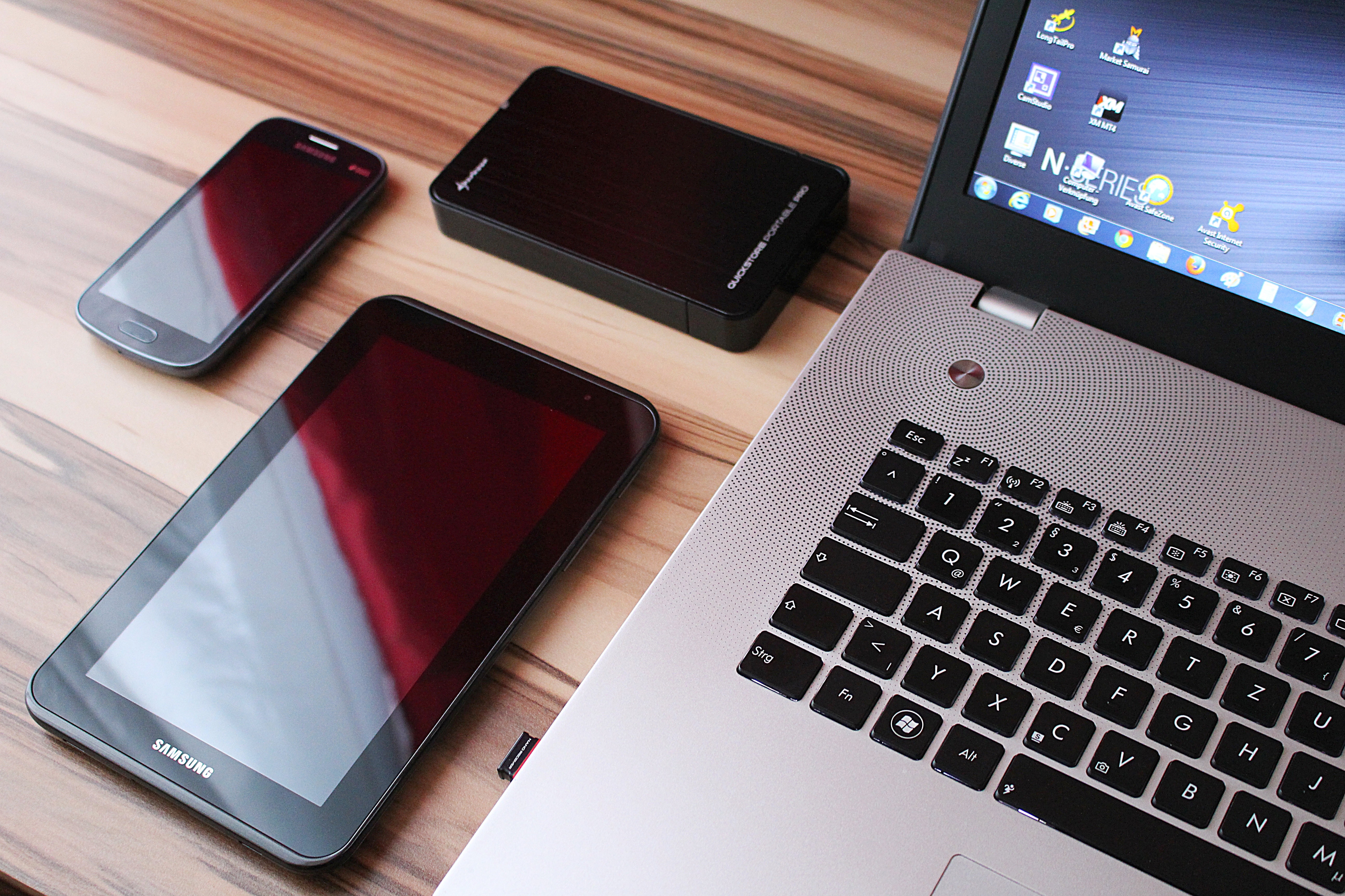 A laptop and various Samsung mobile devices