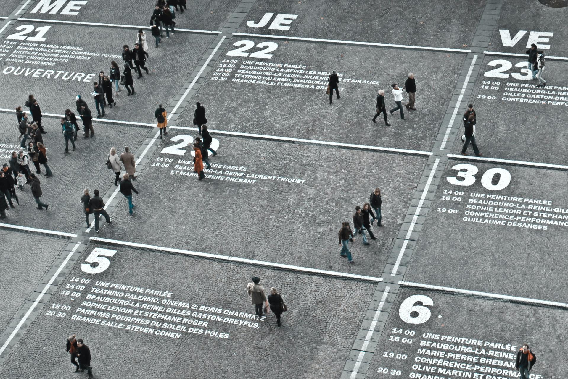 people walking on giant calendar on the ground